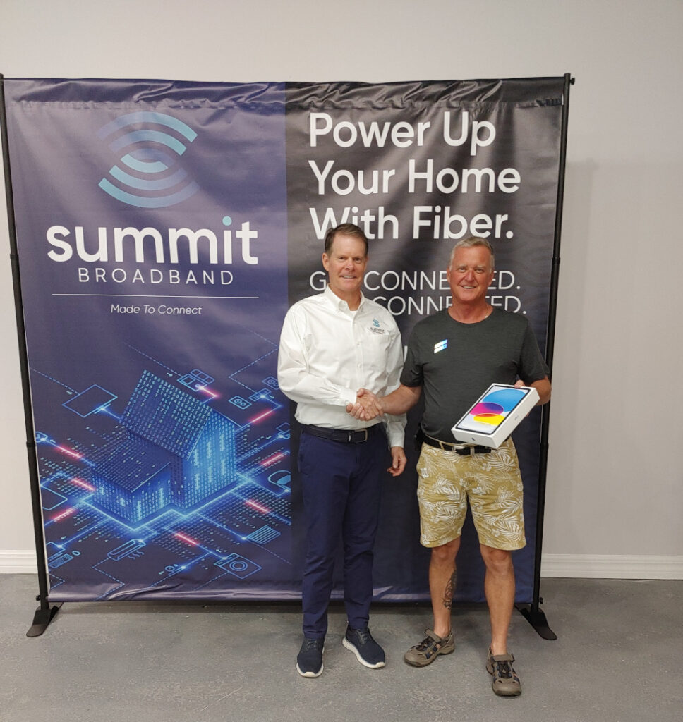 Summit Broadband holiday contest winner with his prize (iPad).