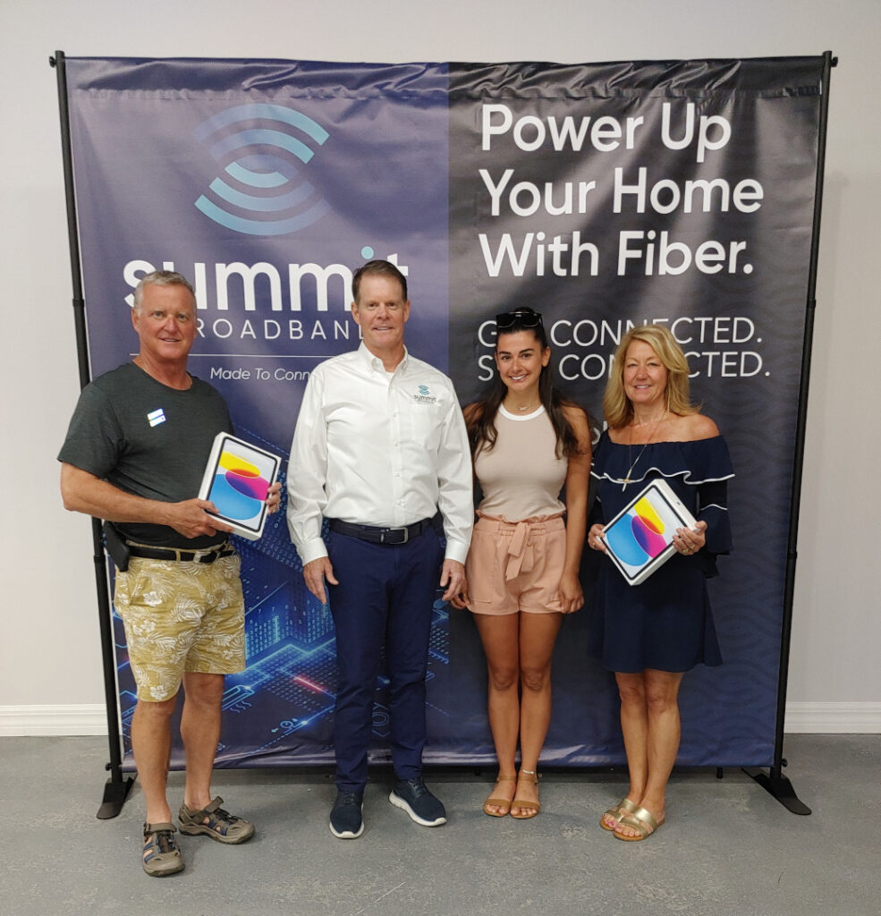 Summit Broadband holiday contest winners with their prizes (iPads).